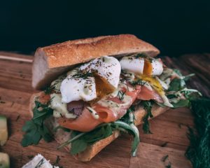 Sandwich mit Lachs, Rucola, Dill und pochierten Eiern